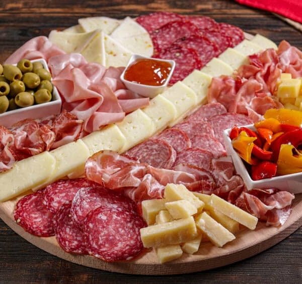 Cured meat and cheese platter with hot sauce